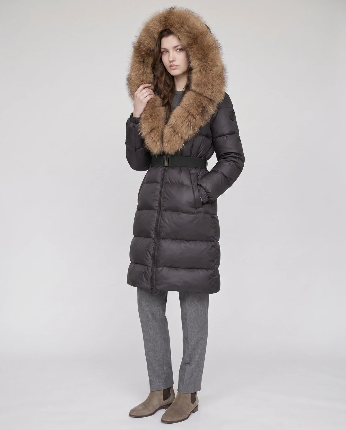 Long belted puffer jacket with a faux fur hood